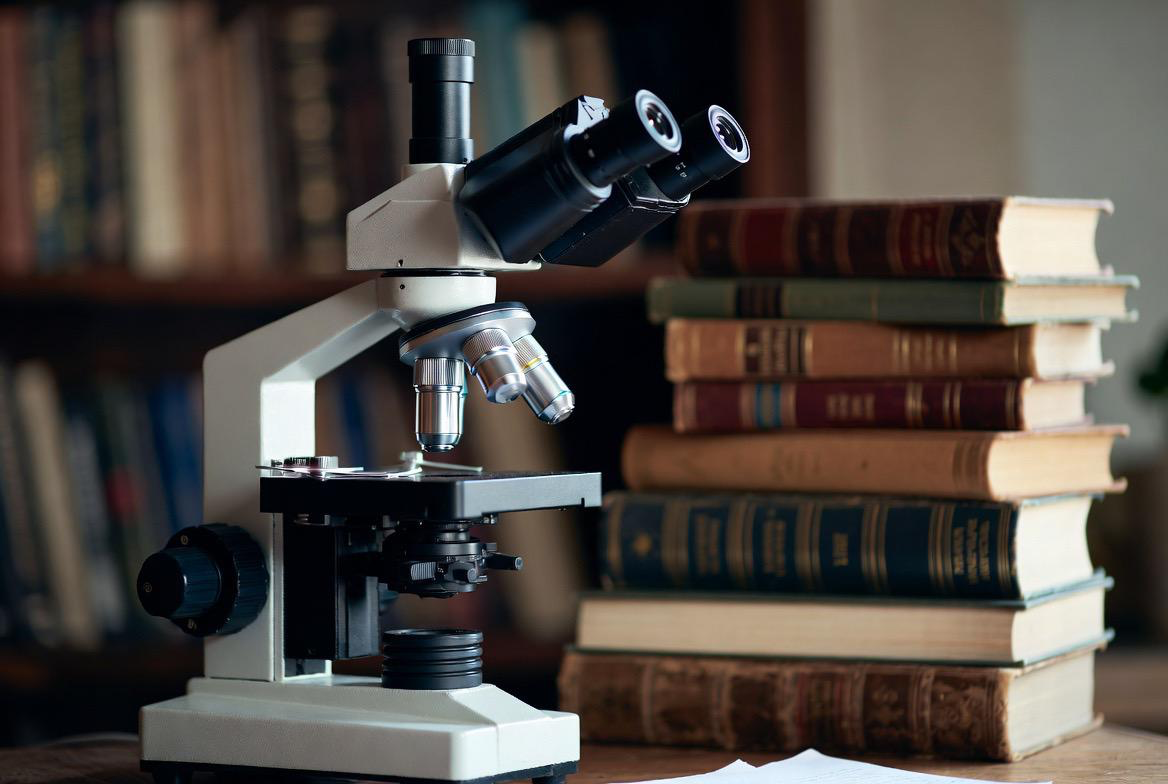 Torah + STEM — microscope alongside stack of books